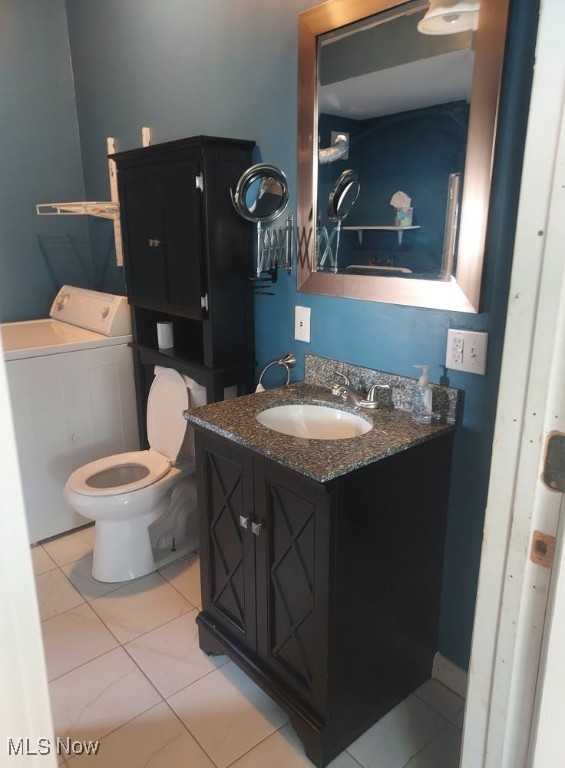 300 37th St, Vienna, WV 26105 - bathroom featuring washer / clothes dryer, vanity, and tile patterned flooring