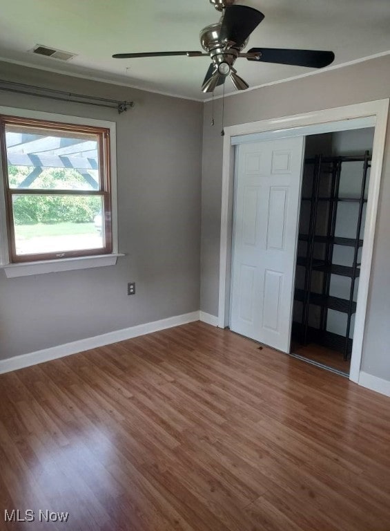 300 37th St, Vienna, WV 26105 - unfurnished bedroom with wood finished floors, ornamental molding, a closet, and a ceiling fan