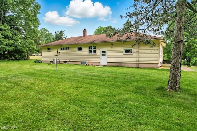 14860 Stoltz Rd, Diamond, OH 44412 - back of house featuring a chimney and a lawn