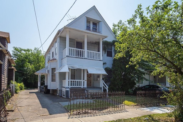 627 E 126th St, Cleveland, OH 44108 - view of property featuring a porch, a fenced front yard, and a balcony