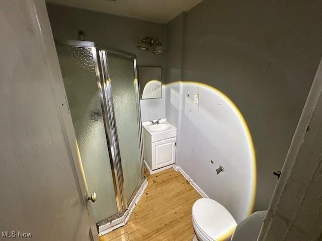 6108 Gateway Blvd S, Elyria, OH 44035 - full bathroom featuring a shower stall, wood finished floors, and vanity