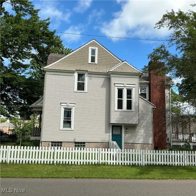 136 High St SE, Canal Fulton, OH 44614 - view of home's exterior with a chimney