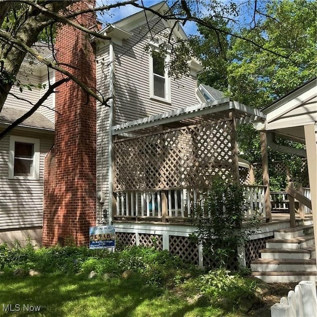 136 High St SE, Canal Fulton, OH 44614 - view of home's exterior with a pergola, a chimney, and a deck