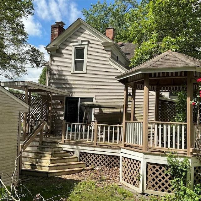 136 High St SE, Canal Fulton, OH 44614 - back of property featuring a chimney, a gazebo, and a deck