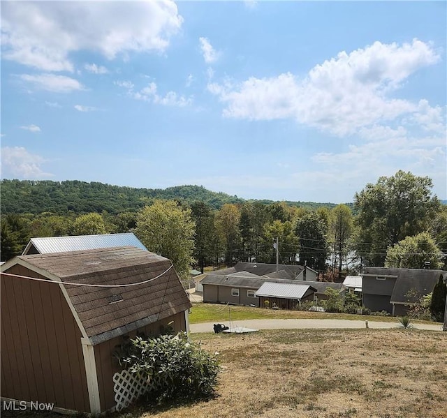 23516 Hideaway Dr, Senecaville, OH 43780 - view of yard featuring a forest view and a storage unit