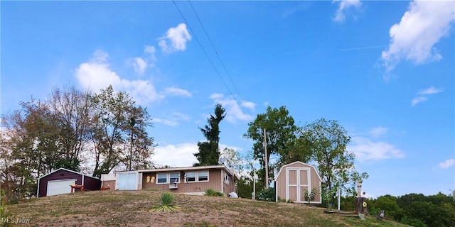 23516 Hideaway Dr, Senecaville, OH 43780 - view of front of home featuring a garage and a storage unit