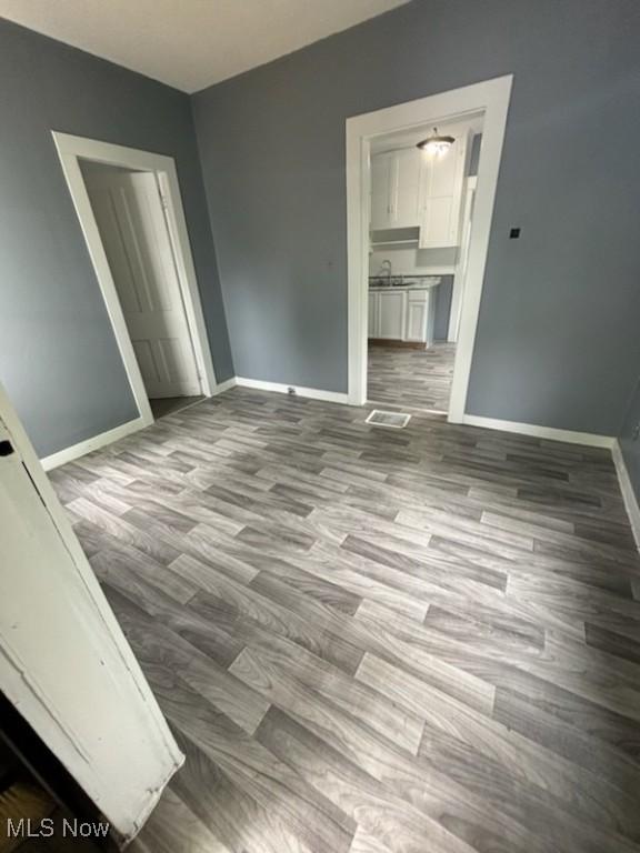 8910 Harris Ave, Cleveland, OH 44104 - empty room with wood finished floors