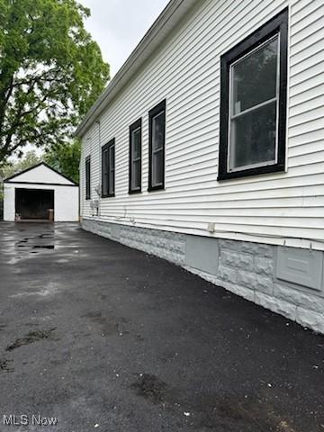8910 Harris Ave, Cleveland, OH 44104 - view of side of home with an outbuilding and a garage
