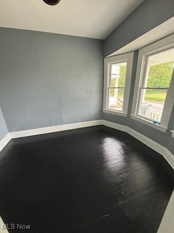 8910 Harris Ave, Cleveland, OH 44104 - unfurnished room featuring lofted ceiling and wood finished floors