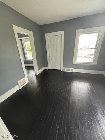 8910 Harris Ave, Cleveland, OH 44104 - unfurnished living room featuring dark wood-type flooring