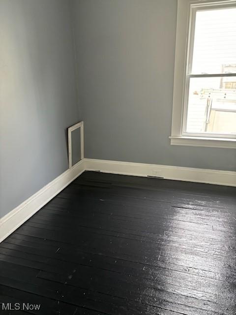 8910 Harris Ave, Cleveland, OH 44104 - empty room featuring dark wood-style flooring