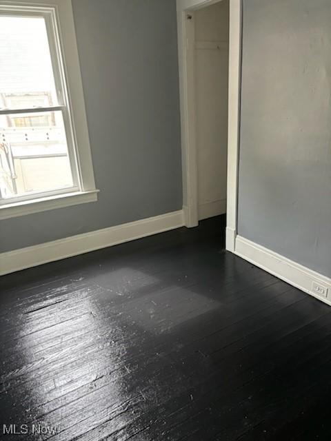 8910 Harris Ave, Cleveland, OH 44104 - spare room featuring healthy amount of natural light and dark wood finished floors