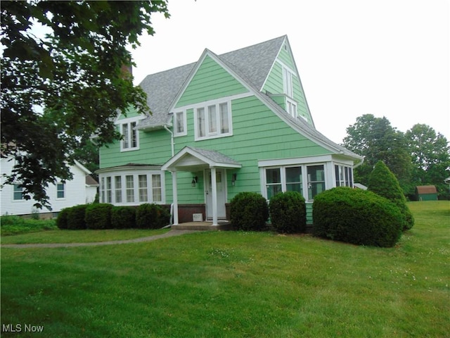 4017 N Ridge Rd W, Saybrook, OH 44004 - view of front of home featuring a front yard and a shingled roof