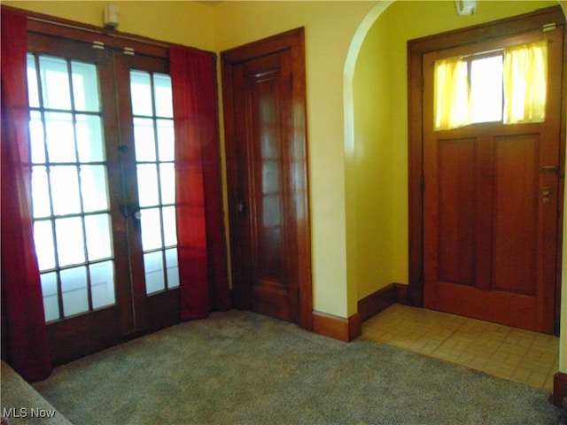 4017 N Ridge Rd W, Saybrook, OH 44004 - foyer featuring french doors, carpet, and arched walkways