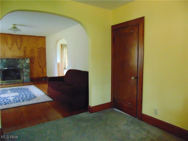 4017 N Ridge Rd W, Saybrook, OH 44004 - carpeted living area with a stone fireplace and arched walkways