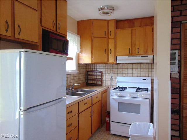 4017 N Ridge Rd W, Saybrook, OH 44004 - kitchen with white appliances, under cabinet range hood, light countertops, and tasteful backsplash