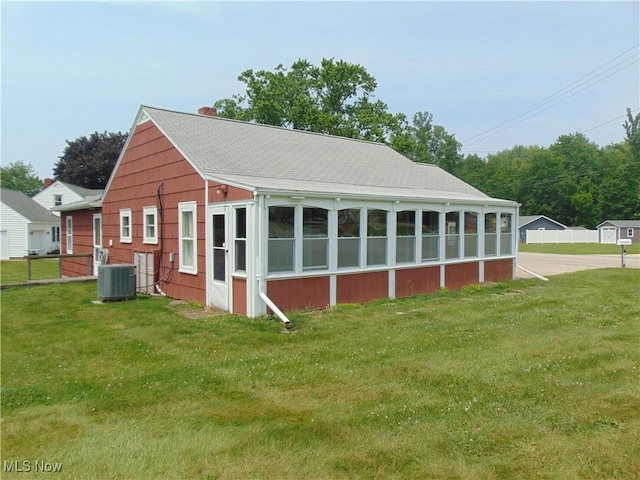 4017 N Ridge Rd W, Saybrook, OH 44004 - view of side of property with a lawn, a chimney, and a shingled roof