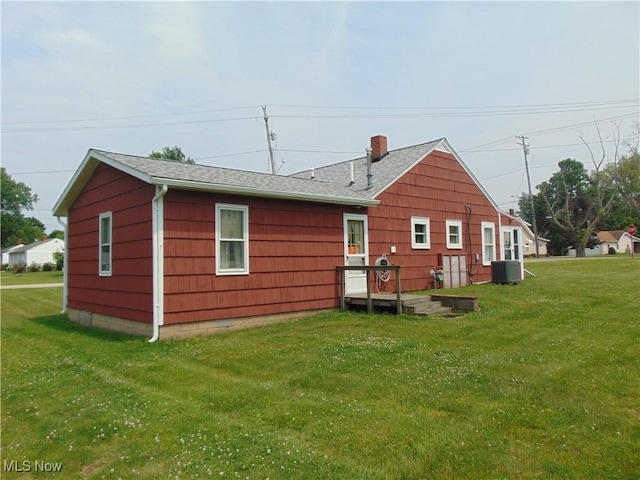 4017 N Ridge Rd W, Saybrook, OH 44004 - rear view of house with a lawn, a shingled roof, and a chimney