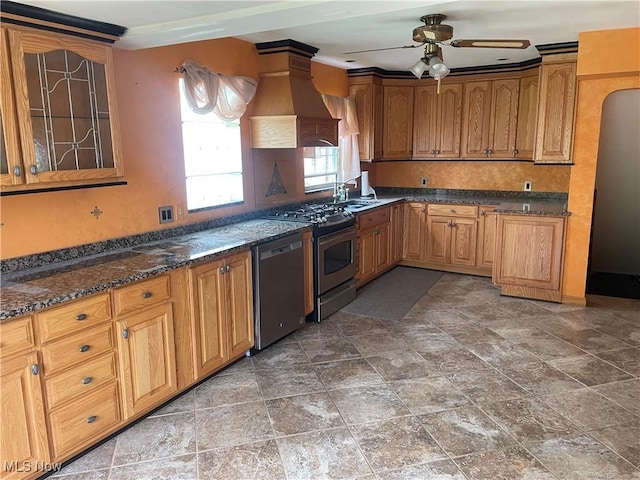 530 Center St, Hubbard, OH 44425 - kitchen featuring stainless steel appliances, custom range hood, ceiling fan, glass insert cabinets, and dark stone countertops
