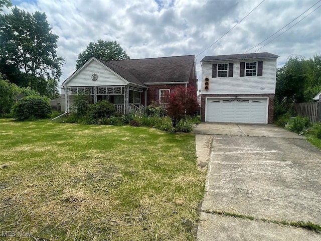 530 Center St, Hubbard, OH 44425 - view of front of house featuring brick siding, driveway, and a garage