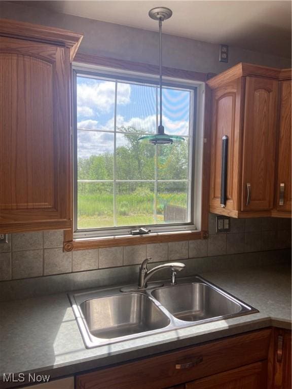 4520 E Wallings Rd, Broadview Heights, OH 44147 - kitchen featuring backsplash, brown cabinetry, and hanging light fixtures