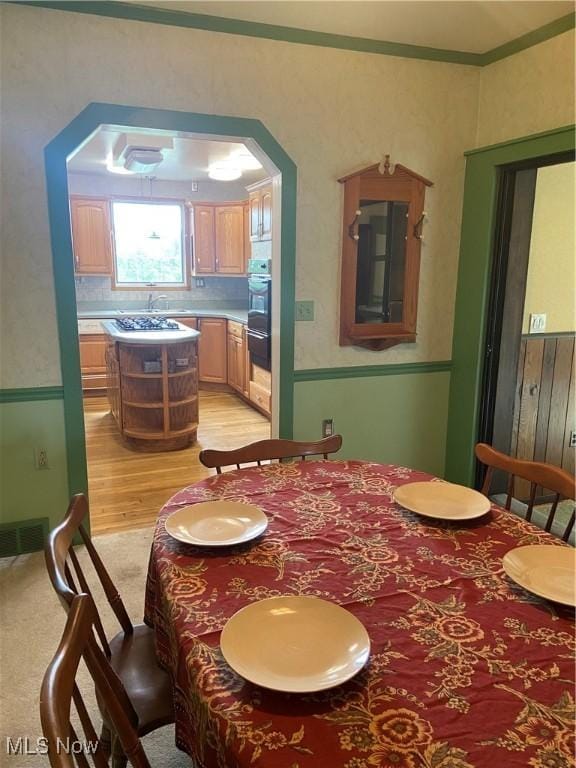 4520 E Wallings Rd, Broadview Heights, OH 44147 - dining area featuring light wood-style flooring, ornamental molding, and arched walkways