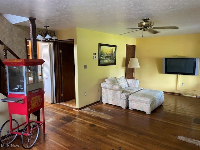 4520 E Wallings Rd, Broadview Heights, OH 44147 - living room featuring wood finished floors, a textured ceiling, a chandelier, and ceiling fan