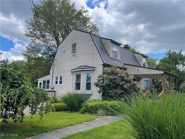 67966 Old Twenty One Rd, Cambridge, OH 43725 - view of property exterior featuring a chimney, a metal roof, a yard, and a gambrel roof