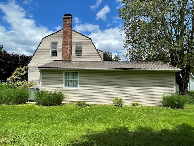 67966 Old Twenty One Rd, Cambridge, OH 43725 - view of property exterior featuring a gambrel roof, a yard, a metal roof, and a chimney