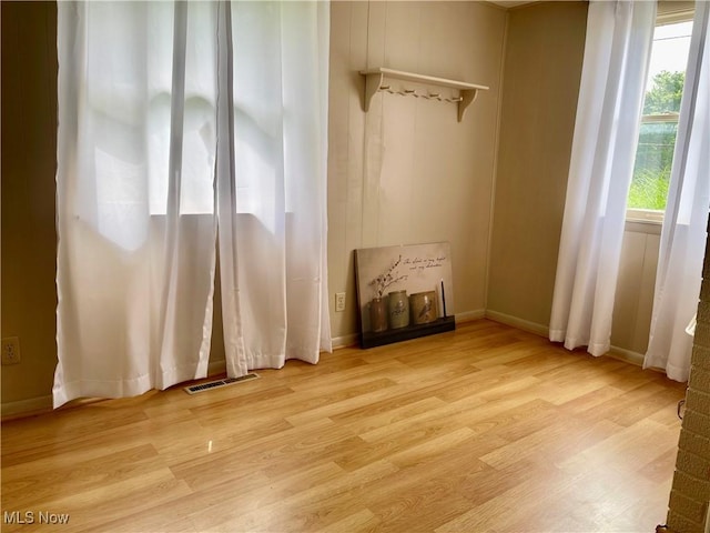 67966 Old Twenty One Rd, Cambridge, OH 43725 - unfurnished living room with light wood-style flooring and baseboards