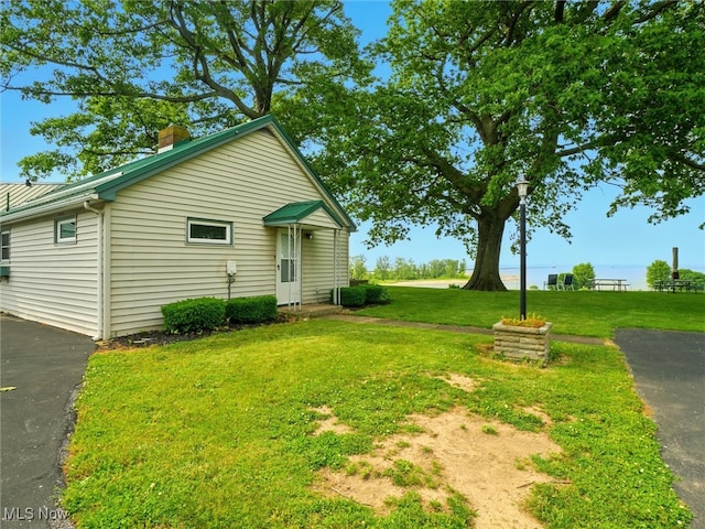 290-289 Park Ave, Conneaut, OH 44030 - view of property exterior featuring a lawn and a chimney