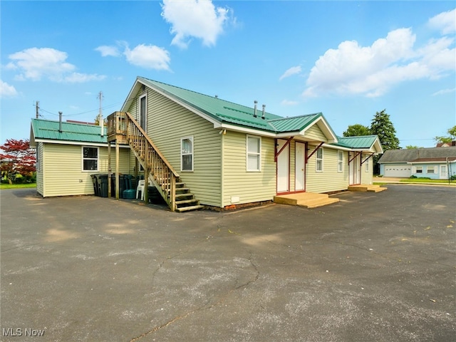 290-289 Park Ave, Conneaut, OH 44030 - view of home's exterior with a metal roof and stairs