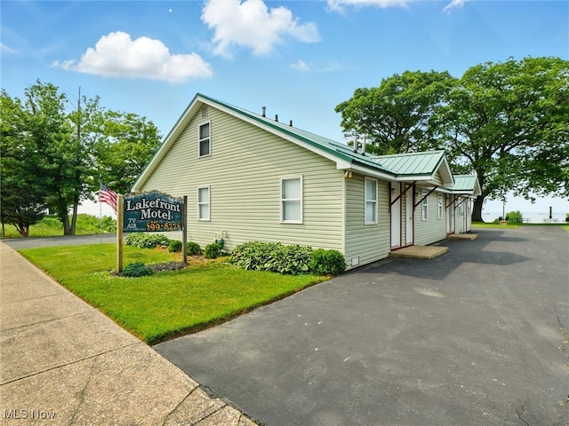 290-289 Park Ave, Conneaut, OH 44030 - view of side of home featuring a yard and a metal roof