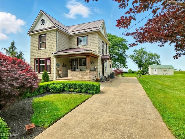 290-289 Park Ave, Conneaut, OH 44030 - view of front of home featuring a metal roof, a front lawn, a standing seam roof, and covered porch