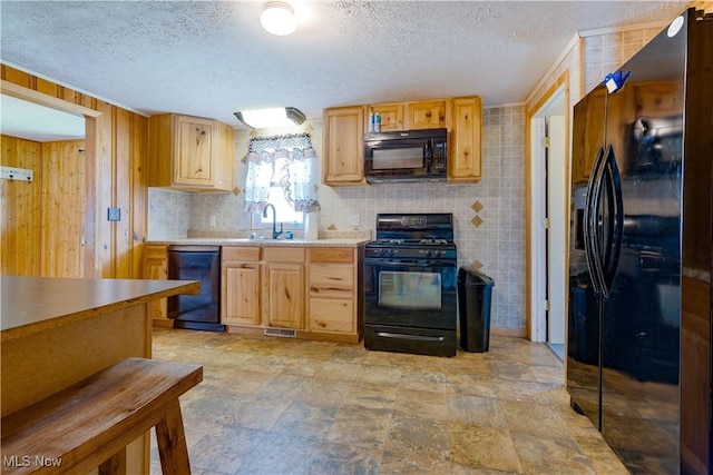 719 Pomeroy Pike, Belpre, OH 45714 - kitchen with black appliances, a textured ceiling, light brown cabinets, light countertops, and wooden walls