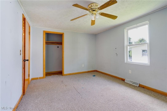 719 Pomeroy Pike, Belpre, OH 45714 - unfurnished bedroom featuring light colored carpet, a textured ceiling, a closet, and ceiling fan