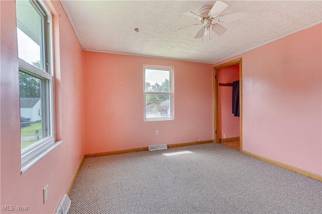 719 Pomeroy Pike, Belpre, OH 45714 - carpeted empty room with ceiling fan, a textured ceiling, and crown molding