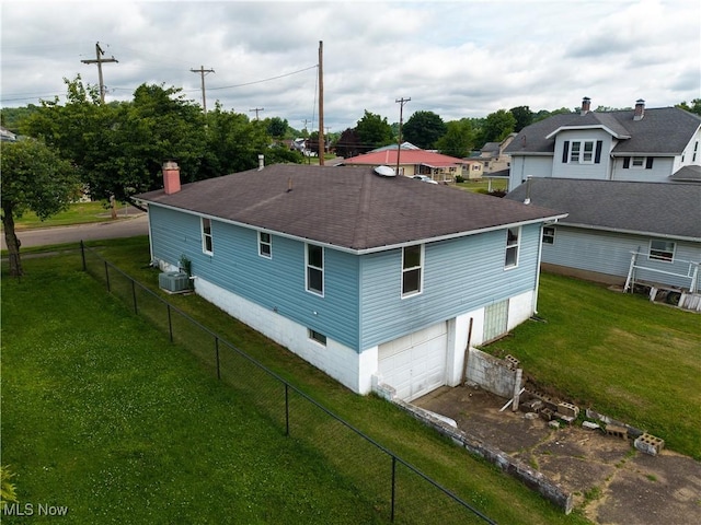 719 Pomeroy Pike, Belpre, OH 45714 - view of home's exterior with a shingled roof, an attached garage, a chimney, and driveway