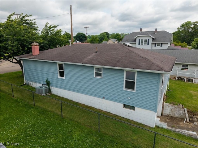 719 Pomeroy Pike, Belpre, OH 45714 - back of house featuring a shingled roof, a fenced backyard, and a chimney
