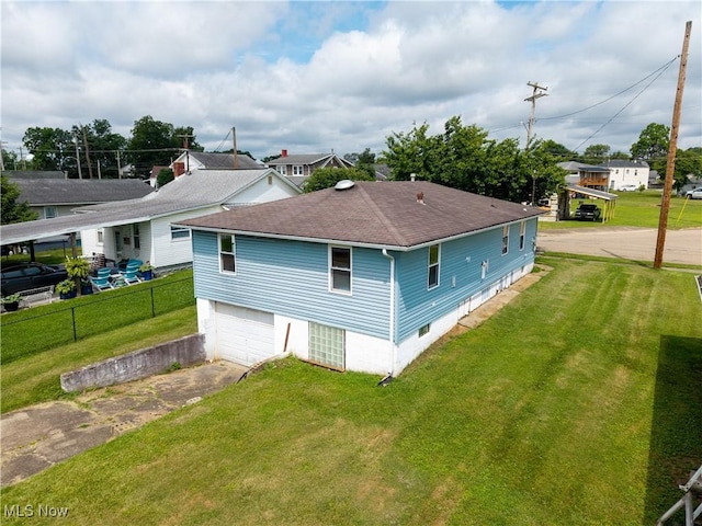 719 Pomeroy Pike, Belpre, OH 45714 - rear view of property with roof with shingles, driveway, and a garage