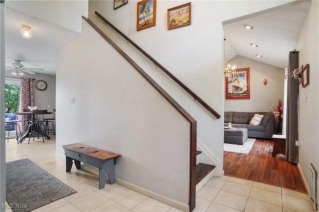 220 Long Rd, Macedonia, OH 44056 - stairs with tile patterned flooring, a chandelier, ceiling fan, and vaulted ceiling