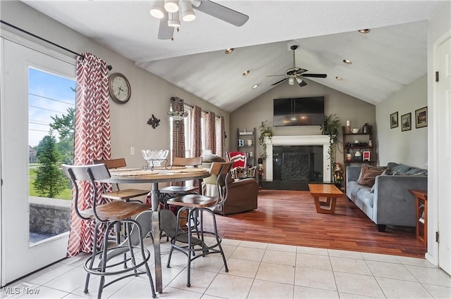 220 Long Rd, Macedonia, OH 44056 - dining space with ceiling fan, light tile patterned floors, a fireplace, lofted ceiling, and recessed lighting