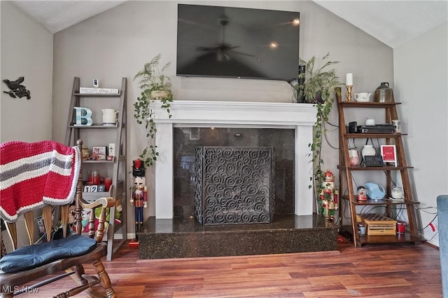220 Long Rd, Macedonia, OH 44056 - living area with a tiled fireplace, wood finished floors, vaulted ceiling, and a ceiling fan