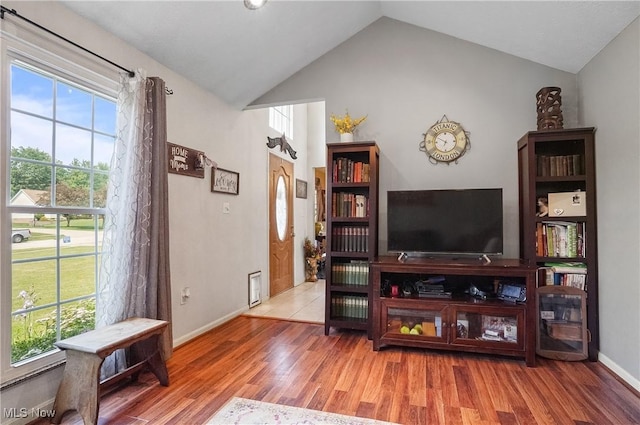 220 Long Rd, Macedonia, OH 44056 - living room with healthy amount of natural light, vaulted ceiling, and wood finished floors