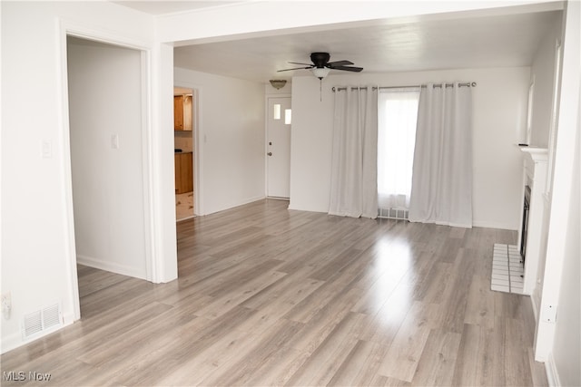 7355 Westview Dr, Boardman, OH 44512 - unfurnished living room with a ceiling fan, light wood-style floors, and a fireplace with flush hearth