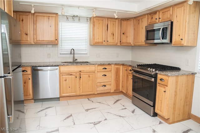 7355 Westview Dr, Boardman, OH 44512 - kitchen with stainless steel appliances, light marble finish flooring, dark stone counters, rail lighting, and backsplash