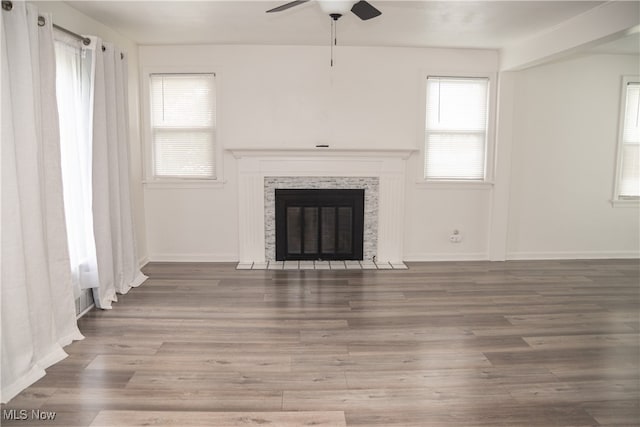 7355 Westview Dr, Boardman, OH 44512 - unfurnished living room featuring a ceiling fan, wood finished floors, and a tiled fireplace