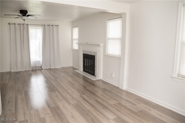 7355 Westview Dr, Boardman, OH 44512 - unfurnished living room featuring a fireplace with flush hearth, light wood-style floors, and a ceiling fan