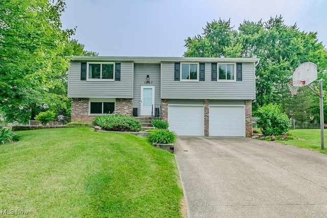 1657 Kasserine Ct, Twinsburg, OH 44087 - split foyer home with brick siding, a garage, a front yard, and concrete driveway