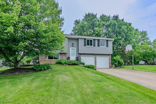 1657 Kasserine Ct, Twinsburg, OH 44087 - bi-level home featuring a garage, brick siding, a front yard, and asphalt driveway